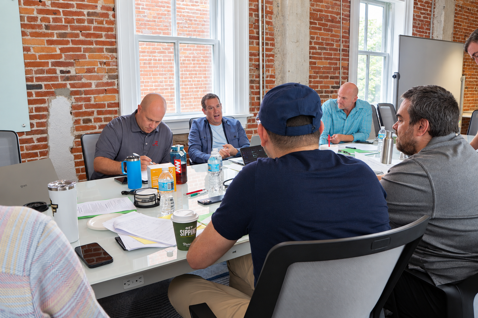 TeamStrength CEO members discussing an issue around the meeting table